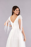 Back of soft tulle tea length wedding dress featuring V-neck and soft boho full skirt.