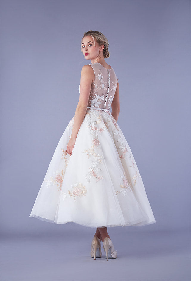 Back of tulle tea length wedding dress with floral appliques throughout bodice and skirt