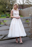 Tulle tea length wedding dress with floral appliques throughout bodice and skirt