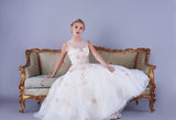 The full skirt of the tulle tea length wedding dress with floral appliques throughout bodice and skirt