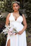 Close up of satin Ivory A-line wedding dress with leg slit, open back and v-neckline