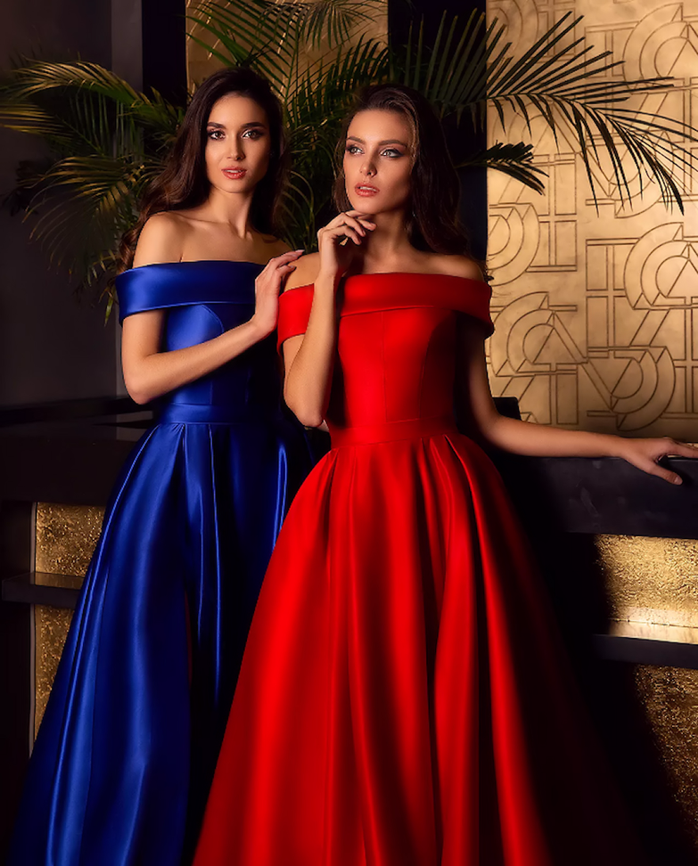 Full length heavy satin gown with dramatic though discreet side split and pockets shown in Blue and Red