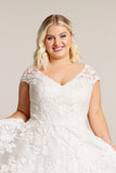Close up of tea length wedding dress in luxury lace and with a deep v neck bodice cut especially for curvy girls.