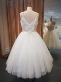 Back of delicate pleated bodice tulle bridal gown with coloured floral embroidery.
