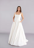 Full length pure simplicity crepe bridal gown with train and skirt pockets