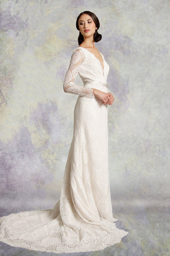 Lace fishtail wedding dress with long sleeves with a  soft satin belt on waistline and deep plunging neckline mirrored with a matching deep V- back