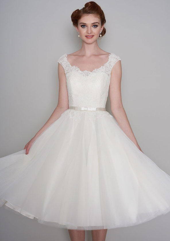 Image of the Flossie tea length Fifties style lace and tulle wedding dress trimmed with a satin bow belt. 