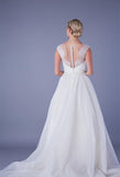 Back of Tea length wedding dress with plunge lace illusion bodice and tulle skirt with pearl and bead waist detailing.