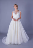 Tea length wedding dress with plunge lace illusion bodice and tulle skirt with pearl and bead waist detailing.