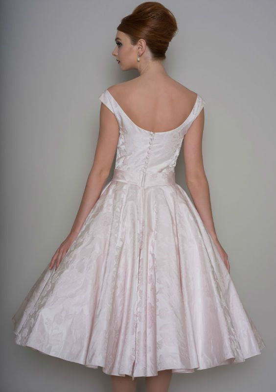 Back of  brocade 50's inspired tea length wedding dress with bow belt and button back bodice.