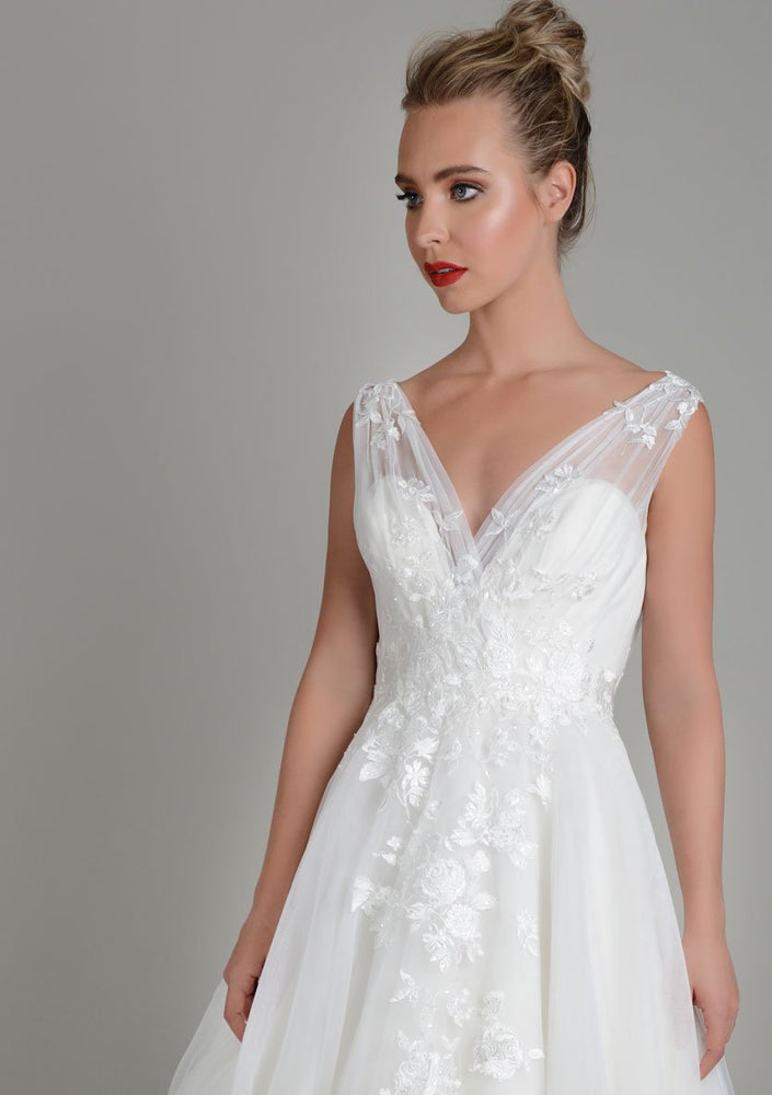 Close up image of Lois Wild Zinnia tea length wedding gown in super soft tulle with delicate lace appliqué