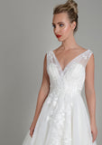 Close up image of Lois Wild Zinnia tea length wedding gown in super soft tulle with delicate lace appliqué