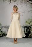 The Cora tea length bridal gown shown in champagne.