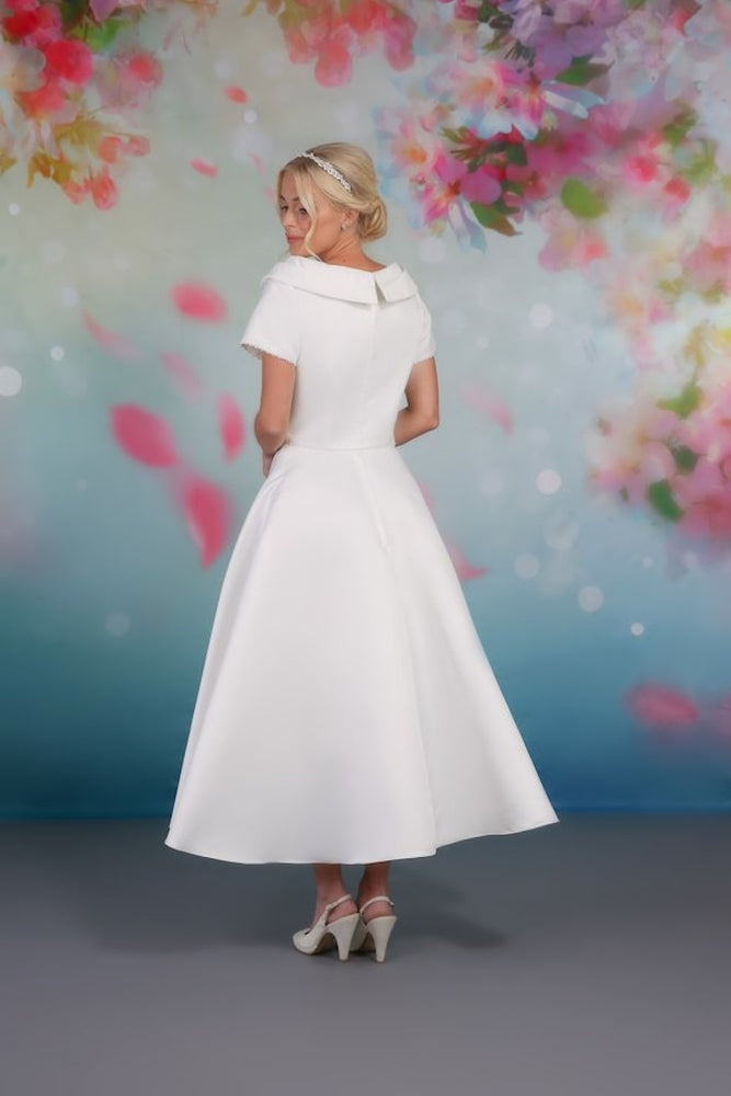 Back of classic design satin tea-length gown with soft A-line skirt and shawl collar rd-nora