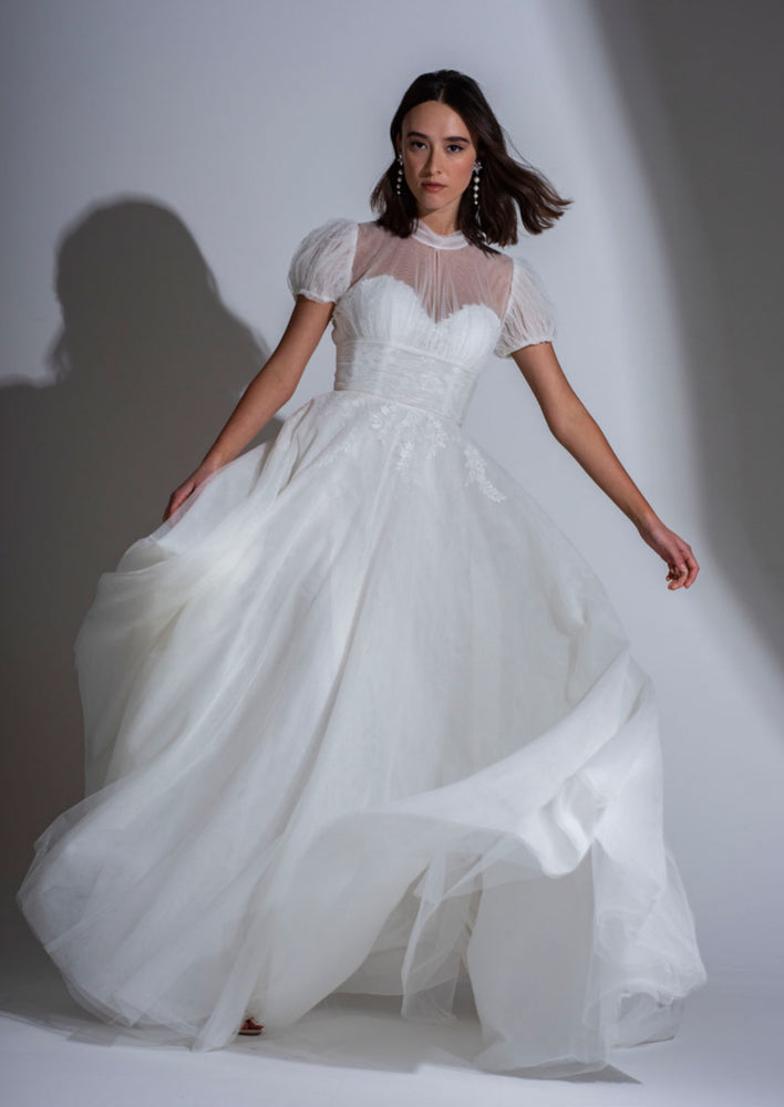 The Adelaide contemporary lace and tulle wedding dress with high neck and small puff sleeves.