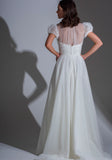 Back of the Adelaide contemporary lace and tulle wedding dress with high neck and small puff sleeves.