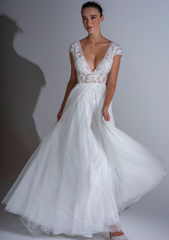 The Roseville is a delicate sheer wedding dress with fitted lace bodice and sparkle tulle layered skirt.