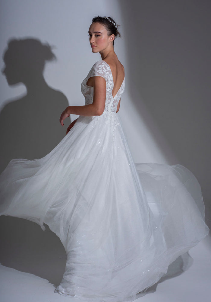 Back of the Roseville delicate sheer wedding dress with fitted lace bodice and sparkle tulle layered skirt.