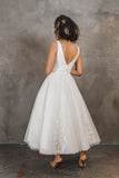 Back of tulle with lace appliqué tea length wedding gown