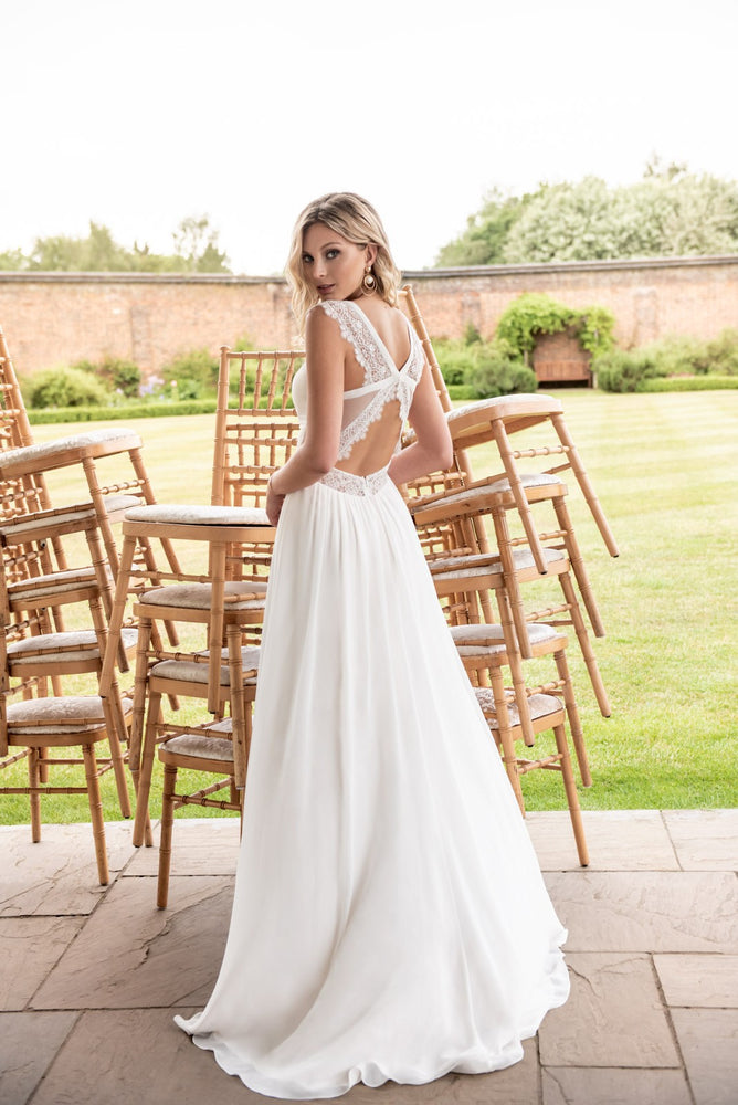 Back of ivory  chiffon Empire line Dress with lace trim details at neckline & waist