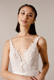 The bodice of the Lyra tulle and lace, V neckline soft silhouette Boho bridal or ball gown with pretty lace over bodice that trails into the skirt.