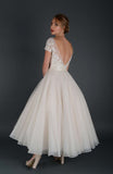 Back of tea length bridal gown with embellished bodice and cap sleeve.