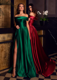 Full length heavy satin gown with dramatic though discreet side split and pockets shown in Green and Red