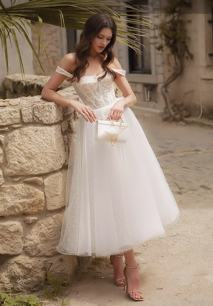 Luxury exposed boning corset style wedding dress with full tea length spotty tulle skirt. om-marisa